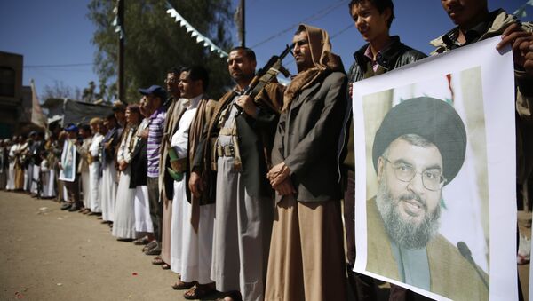 Shiite rebels, known as Houthis, hold a poster of Hezbollah leader Sheikh Hassan Nasrallah during a gathering to show their support to Hezbollah in Sanaa, Yemen, Thursday, March 3, 2016 - Sputnik International