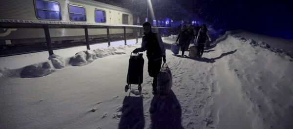 Refugees disembark and make their way to a camp at a hotel touted as the world's most northerly ski resort in Riksgransen, Sweden, in this December 15, 2015 file photo Refugees disembark and make their way to a camp at a hotel touted as the world's most northerly ski resort in Riksgransen, Sweden, in this December 15, 2015 file photo - Sputnik International