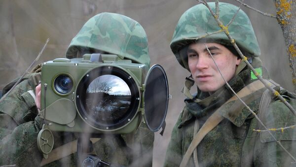 Soldiers of the technical intelligence unit handle an Ironia optical surveillance system during exercise of the Southern Military District special mission brigade in the Krasnodar Territory. The small-size multi-functional electronic optical device is designed for real-time obtaining and processing of information - Sputnik International