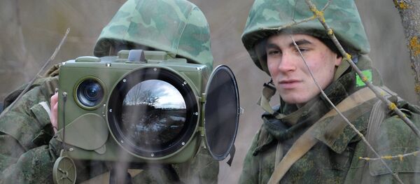 Soldiers of the technical intelligence unit handle an Ironia optical surveillance system during exercise of the Southern Military District special mission brigade in the Krasnodar Territory. The small-size multi-functional electronic optical device is designed for real-time obtaining and processing of information - Sputnik International