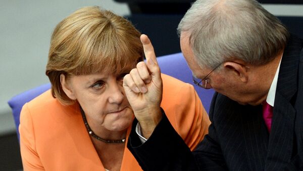 German Chancellor Angela Merkel (L) and German Finance Minister Wolfgang Schaeuble speaks during a session of the Bundestag, the lower house of parliament in Berlin on July 19, 2012. - Sputnik International