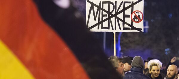 People wave German flags in Erfurt, central Germany,during a demonstration initiated by the Alternative for Germany (AfD) party against the immigration situation (File) - Sputnik International