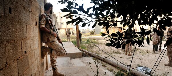 In this Monday, March 7, 2016 photo, men loyal to Libyan armed forces stand alert during clashes with Islamic State group militants west of Benghazi, Libya In this Monday, March 7, 2016 photo, men loyal to Libyan armed forces stand alert during clashes with Islamic State group militants west of Benghazi, Libya - Sputnik International