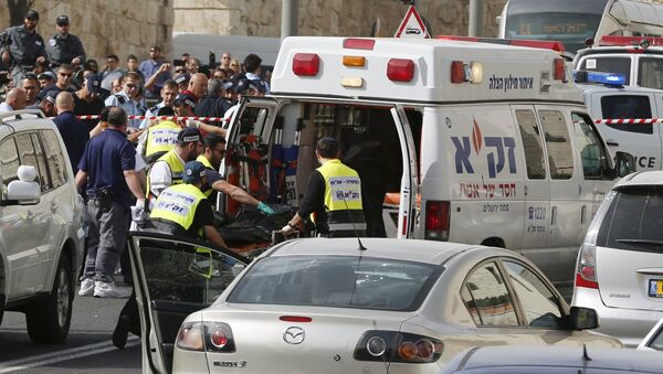Israeli emergency personnel evacuate the body of one of the two Palestinian assailants whom police said carried out a drive-by shooting on cars in an east Jerusalem suburb before being shot dead by police opposite the Notre Dame Center just outside Jerusalem's Old City March 9, 2016 - Sputnik International