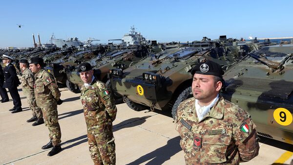 Italian Army soldiers stand by some of the twenty military vehicles during an handing over ceremony by Italy to Libya at a Libyan Navy Base on February 6, 2013 in Tripoli. - Sputnik International