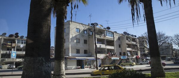 In this photo taken on Tuesday, March 1, 2016, a car passes on a street in Latakia, Syria. Associated Press spent five days traveling through the port of Latakia in Syria during the ceasefire. - Sputnik International