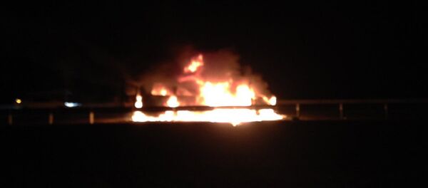 A small bus on fire which was carrying foreign and Russian journalists, and activists from a non-governmental organization, is seen after been attacked near the border of Chechnya by men in Ingushetia, South Russia - Sputnik International