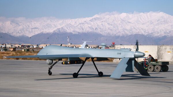 A US Predator unmanned drone armed with a missile setting off from its hangar at Bagram air base in Afghanistan. File photo - Sputnik International