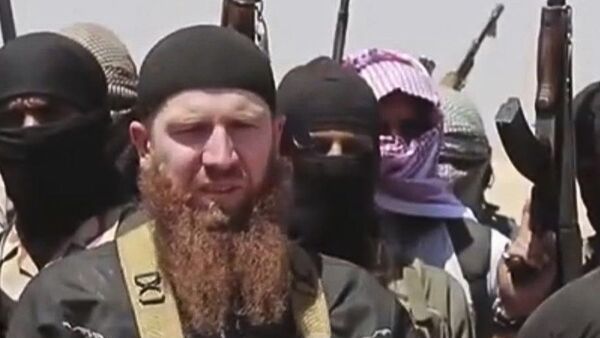 Omar al-Shishani standing next to the group's spokesman among a group of fighters as they declare the elimination of the border between Iraq and SyriaDaesh leader Abu Omar al-Shishani. (File) - Sputnik International