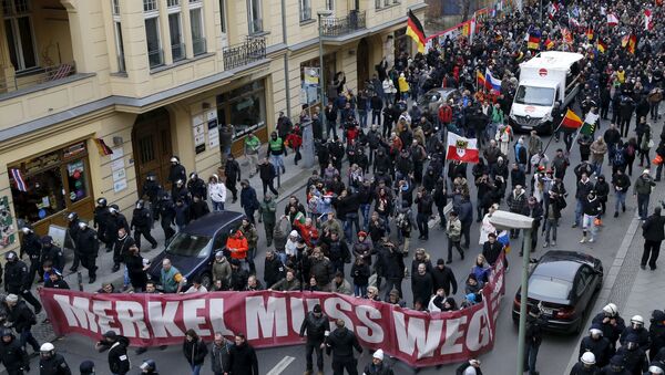 Far right-wing supporters march during rally against the German government's immigration policies and migrants, near-by the Chancellery in Berlin, Germany. - Sputnik International