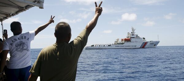 Filipino soldiers gesture at a Chinese Coast Guard vessel on the disputed Second Thomas Shoal, part of the Spratly Islands, in the South China Sea March 29, 2014 Filipino soldiers gesture at a Chinese Coast Guard vessel on the disputed Second Thomas Shoal, part of the Spratly Islands, in the South China Sea March 29, 2014 - Sputnik International