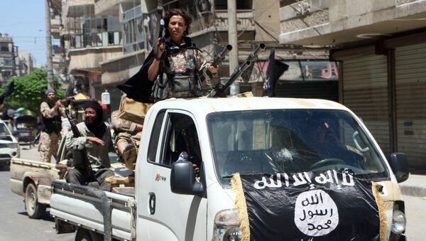 Fighters from Al-Qaeda's Syrian affiliate Al-Nusra Front drive in armed vehicles in the northern Syrian city of Aleppo as they head to a frontline, on May 26, 2015 - Sputnik International