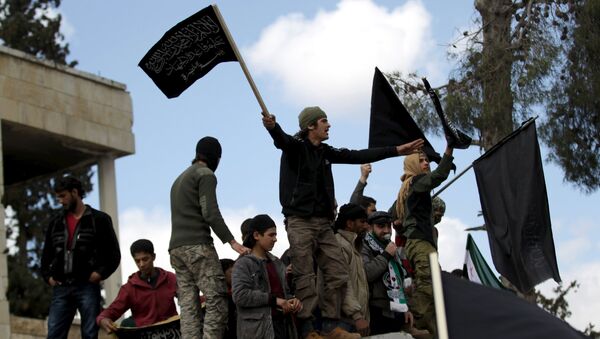 Protesters carry Nusra Front flags and shout slogans during an anti-government protest after Friday prayers in the town of Marat Numan in Idlib province, Syria, March 11, 2016 - Sputnik International