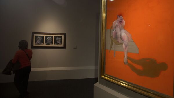 A woman looks at Francis Bacon's 3 Studies of Peter Beard left alongside part of Bacon's Triptych at the Abello Collection exhibition in Madrid, Spain, Wednesday, Nov. 5, 2014. - Sputnik International
