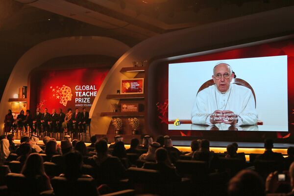 Pope Francis speaks live via video link before he introduces the winner of the second annual Global Teacher Prize, Palestinian primary school teacher Hanan al-Hroub, in Dubai, United Arab Emirates, Sunday, March 13, 2016 Pope Francis speaks live via video link before he introduces the winner of the second annual Global Teacher Prize, Palestinian primary school teacher Hanan al-Hroub, in Dubai, United Arab Emirates, Sunday, March 13, 2016 - Sputnik International