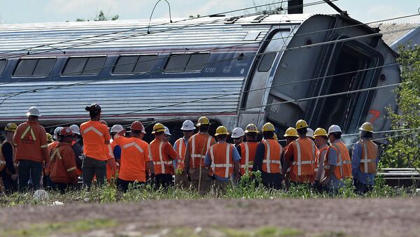 Rescuers gather around a derailed carriage of an Amtrak train in Philadelphia, Pennsylvania, on May 13, 2015 file photo - Sputnik International