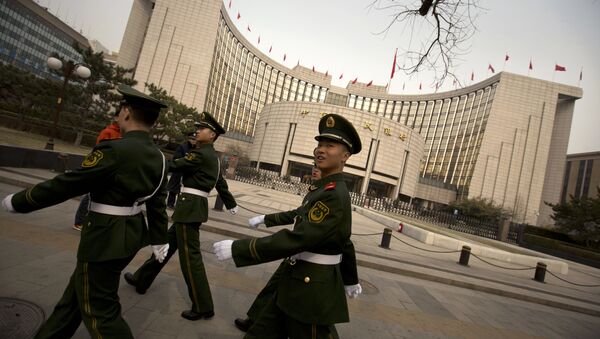 Chinese paramilitary police march past China's central bank, the People's Bank of China, in Beijing, Saturday, March 12, 2016 - Sputnik International