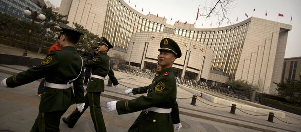 Chinese paramilitary police march past China's central bank, the People's Bank of China, in Beijing, Saturday, March 12, 2016 Chinese paramilitary police march past China's central bank, the People's Bank of China, in Beijing, Saturday, March 12, 2016 - Sputnik International