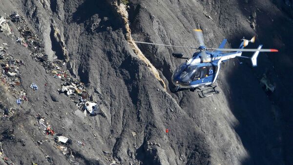 A French Gendarmerie rescue helicopter flies over the debris of the Germanwings Airbus A320 at the site of the crash, near Seyne-les-Alpes, France, in this picture taken on March 27, 2015. French BEA air accident investigators reported March 13, 2016 that a doctor had recommended that the German pilot who crashed a Germanwings jet into the Alps last year should be treated in a psychiatric hospital two weeks before the disaster - Sputnik International