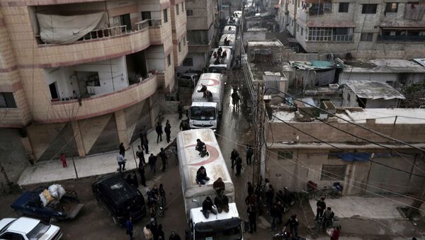 This file photo taken on February 23, 2016 shows a Red Crescent convoy carrying humanitarian aid arriveing in Kafr Batna, in the rebel-held Eastern Ghouta area, on the outskirts of the capital Damascus during an operation in cooperation with the UN to deliver aid to thousands of besieged Syrians - Sputnik International