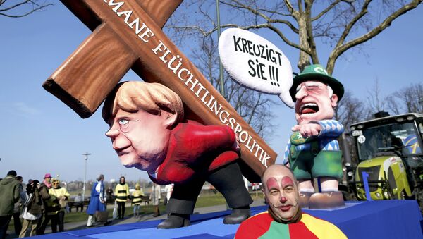 A carnival float with papier-mache caricatures mocking Bavarian Governor Horst Seehofer and German Chancellor Angela Merkel is displayed at a postponed Rosenmontag (Rose Monday) parade, at one location in Duesseldorf, Germany, March 13, 2016 - Sputnik International