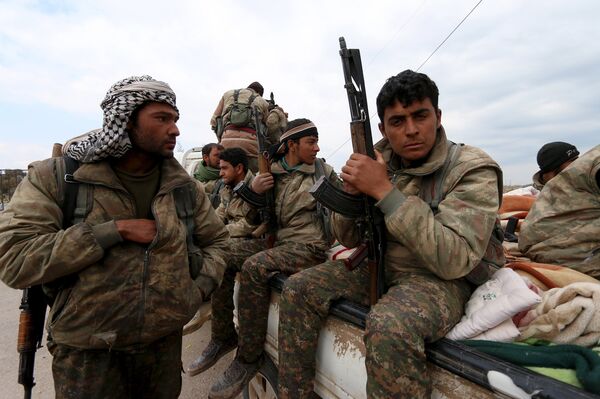 Kurdish People's Protection Units (YPG) fighters carry their weapons while riding on the back of a pick-up truck in Qamishli, Syria, March 11, 2016 - Sputnik International