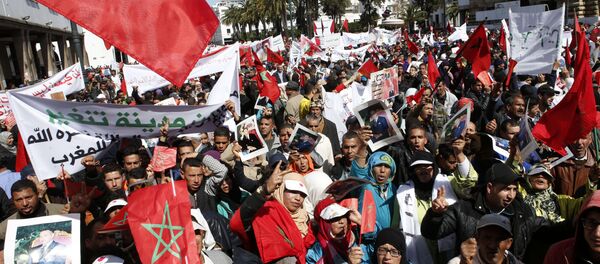 Protesters hold portraits of Morocco's King Mohammed VI and the Moroccan flag as they chant slogans during a rally, in Rabat, Morocco, Sunday, March 13, 2016. Morocco has accused U.N. Secretary-General Ban Ki-moon of abandoning neutrality, objectivity and impartiality during a recent visit to Western Saharan refugee camps in southern Algeria Protesters hold portraits of Morocco's King Mohammed VI and the Moroccan flag as they chant slogans during a rally, in Rabat, Morocco, Sunday, March 13, 2016. Morocco has accused U.N. Secretary-General Ban Ki-moon of abandoning neutrality, objectivity and impartiality during a recent visit to Western Saharan refugee camps in southern Algeria - Sputnik International