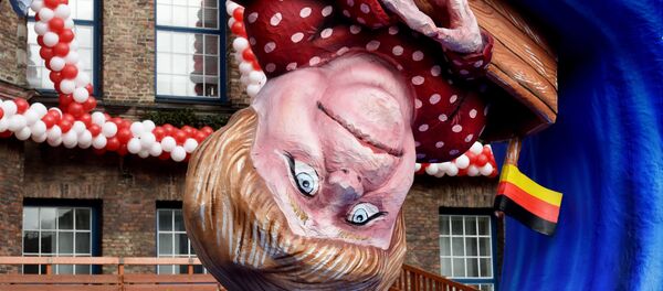 A carnival float depicting German Chancellor Angela Merkel in a small boat on a wave. A carnival float depicting German Chancellor Angela Merkel in a small boat on a wave. - Sputnik International