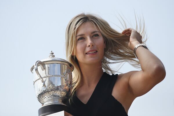 Russia's Maria Sharapova poses with the Suzanne Lenglen trophy in Paris on June 8, 2014 a day after winning the Roland Garros French Tennis Open - Sputnik International