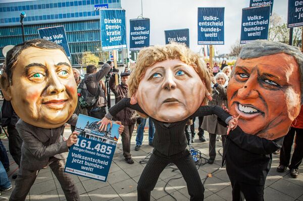 Protesters wearing masks of Sigmar Gabriel, Angela Merkel and Horst Seehofer. Protesters wearing masks of Sigmar Gabriel, Angela Merkel and Horst Seehofer. - Sputnik International