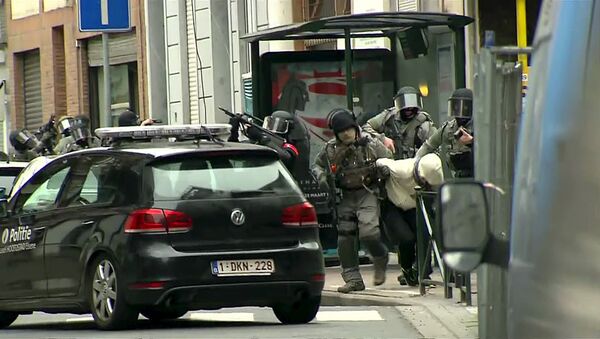 Armed Belgian police apprehend a suspect, in this still image taken from video, in Molenbeek, near Brussels, Belgium, March 18, 2016. Belgian-born Salah Abdeslam, one of the main suspects from November's Paris attacks, was arrested after a shootout with police in Brussels on Friday, the Belgian federal prosecutor's office said. - Sputnik International