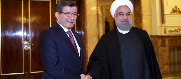 Iranian President Hassan Rouhani (R) shakes hands with Turkish Prime Minister Ahmet Davutoglu before their meeting in Tehran, Iran March 5, 2016. Iranian President Hassan Rouhani (R) shakes hands with Turkish Prime Minister Ahmet Davutoglu before their meeting in Tehran, Iran March 5, 2016. - Sputnik International