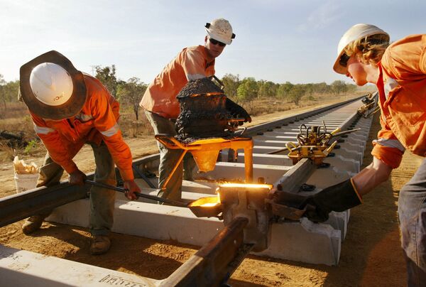 Workers check a joint they have welded on the Alice Springs to Darwin railway line near Adelaide River, Australia. (File) Workers check a joint they have welded on the Alice Springs to Darwin railway line near Adelaide River, Australia. (File) - Sputnik International