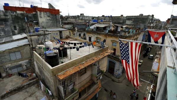 US and Cuban flags are seen on a balcony in Havana, Cuba March 19, 2016. - Sputnik International