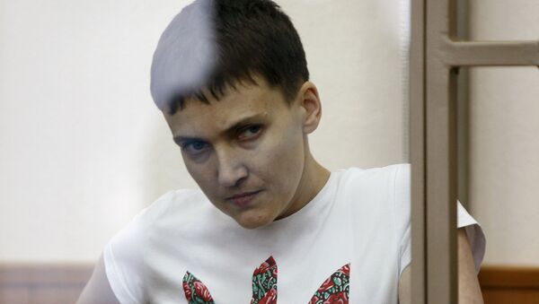 Former Ukrainian army pilot Nadezhda Savchenko looks out from a glass-walled cage as she attends a court hearing in the southern border town of Donetsk in Rostov region, Russia, in this file picture taken March 9, 2016 - Sputnik International