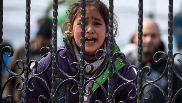A migrant girl cries as she waits at a Turkish coast guard station at the Dikili district in Izmir, on March 20, 2016, after being catched with other migrants while trying to reach the Greek island of Lesbos from the Bademli village, western Turkey. - Sputnik International
