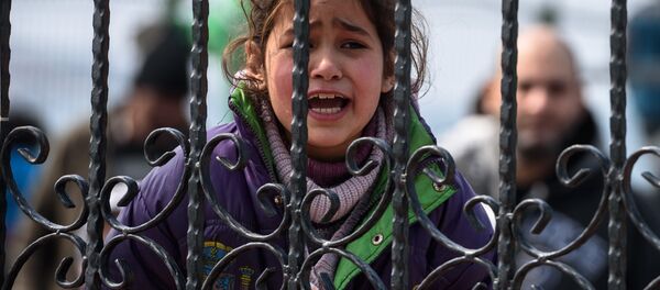 A migrant girl cries as she waits at a Turkish coast guard station at the Dikili district in Izmir, on March 20, 2016, after being catched with other migrants while trying to reach the Greek island of Lesbos from the Bademli village, western Turkey. A migrant girl cries as she waits at a Turkish coast guard station at the Dikili district in Izmir, on March 20, 2016, after being catched with other migrants while trying to reach the Greek island of Lesbos from the Bademli village, western Turkey. - Sputnik International