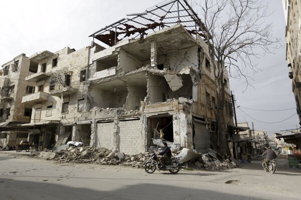 A man rides a motorbike near damaged buildings in the town of Marat Numan in Idlib province, Syria, March 19, 2016 A man rides a motorbike near damaged buildings in the town of Marat Numan in Idlib province, Syria, March 19, 2016 - Sputnik International