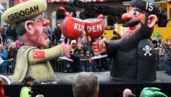A carnival float depicting Turkish President Recep Tayyip Erdogan (L) clinking his glass with a fighter of the Islamic State (IS) stands in front of the city hall in Duesseldorf, western Germany, after the Rose Monday (Rosenmontag) street parade has been cancelled on February 8, 2016 - Sputnik International
