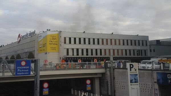 In this image provided by Daniela Schwarzer, smoke is seen at Brussels airport in Brussels, Belgium, after explosions were heard Tuesday, March 22, 2016 - Sputnik International