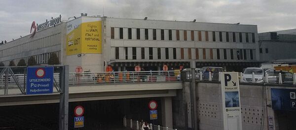 In this image provided by Daniela Schwarzer, smoke is seen at Brussels airport in Brussels, Belgium, after explosions were heard Tuesday, March 22, 2016 - Sputnik International