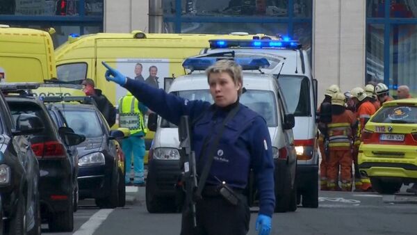 A police woman gestures in front of ambulances at the scene of a blast outside a metro station in Brussels, in this still image taken from video on March 22, 2016 - Sputnik International