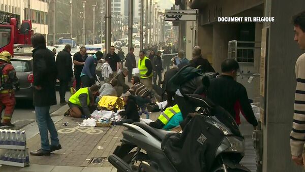 Rescue workers treat victims outside the Maelbeek metro station after a blast, in Brussels, Belgium, in this image taken from a March 22, 2016 video - Sputnik International