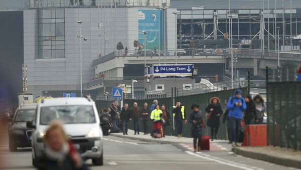People leave the scene of explosions at Zaventem airport near Brussels, Belgium, March 22, 2016. - Sputnik International