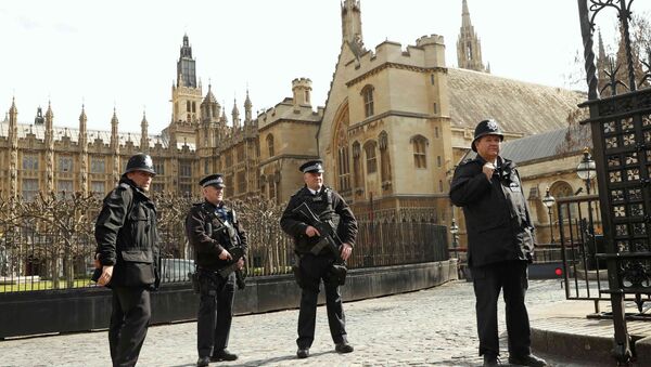 Armed police stand on guard at the Houses of Parliament in London, Britain March 22, 2016. Britain's Prime Minister David Cameron said he would chair a crisis response meeting following explosions in Brussels on Tuesday - Sputnik International