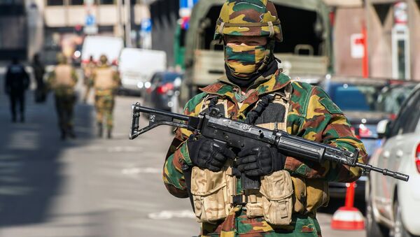 A soldier blocks the access to roads close to the Maalbeek metro station in Brussels on March 22, 2016 after a series of apparently coordinated explosions ripped through Brussels airport and a metro train, killing at least 14 people in the airport and 20 people in the metro in the latest attacks to target Europe - Sputnik International