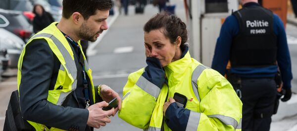 People react outside Brussels airport after explosions rocked the facility in Brussels, Belgium Tuesday March 22, 2016 - Sputnik International