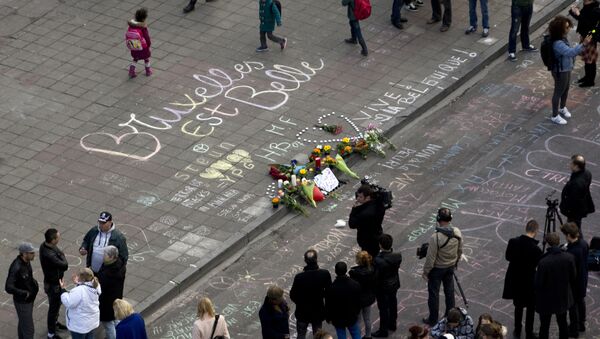 People gather around a makeshift memorial at Place de la Bourse (Beursplein) following attacks in Brussels on March 22, 2016 - Sputnik International