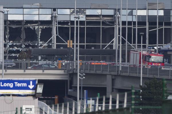 The blown out facade of the terminal is seen as a fire truck drives down the ramp at Zaventem airport, one of the sites of two deadly attacks in Brussels, Belgium, Tuesday, March 22, 2016 The blown out facade of the terminal is seen as a fire truck drives down the ramp at Zaventem airport, one of the sites of two deadly attacks in Brussels, Belgium, Tuesday, March 22, 2016 - Sputnik International