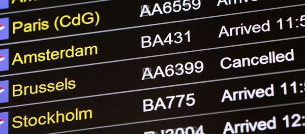 An arrivals board displays a cancelled flight from Brussels with an American Airlines code at Terminal 5, Heathrow Airport in London, Britain March 22, 2016 - Sputnik International